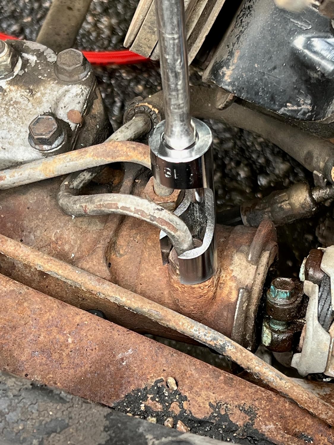 Britool Hallmark 14pc difficult access socket set in use around engine piping using extension bar.